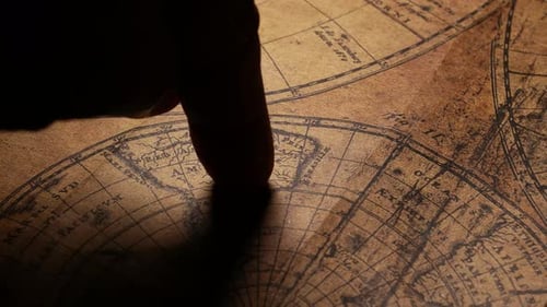 Finger Points to Location on an Antique World Map