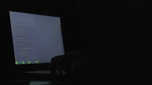 Code on Laptop Screen in Dark Room