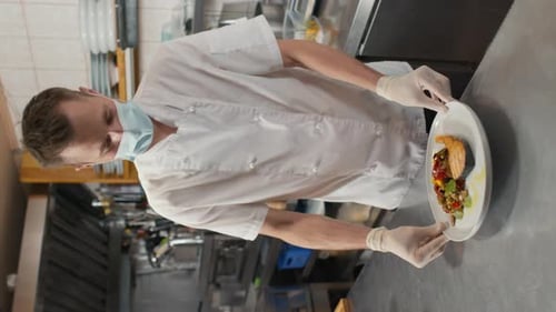 Restaurant Chef Presents Salmon Meal in Kitchen