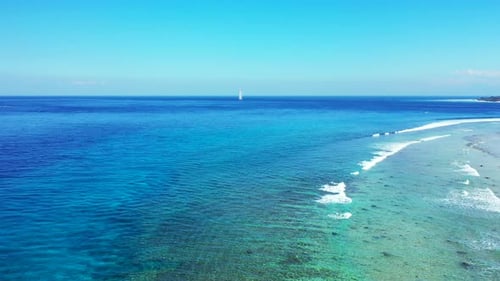 Amazing seascape of tropical shore with white waves splashing and foaming slowly over rocky seabed u