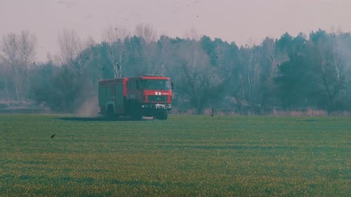 Fire Truck Rides Into the Forest To Extinguish a Forest Fire. Thick Smoke Around