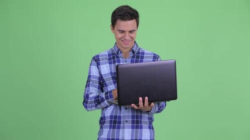 Young Adult Using Laptop on Green Screen