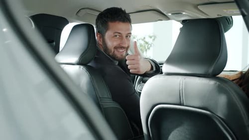 Man Giving Thumbs Up in a Car
