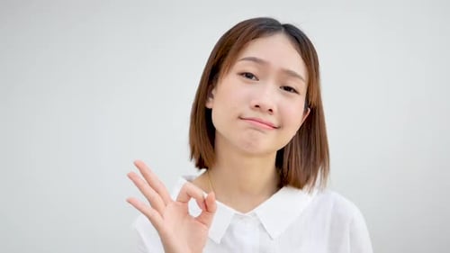 Young Adult Woman Makes OK Hand Gesture