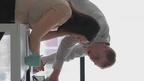 Teamwork in Office Looking at Paperwork