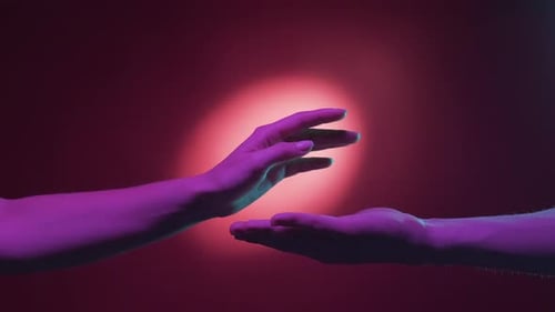 Hands Meet in Loving Touch on Red Background