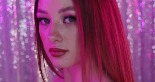 Woman Posing with Makeup in Front of Backdrop