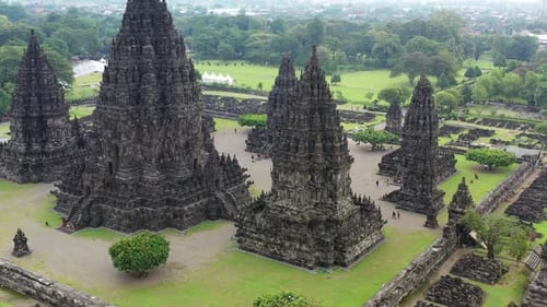 Prambanan Hindu temple in Yogyakarta, Indonesia during rainy season, Aerial pedestal rising shot