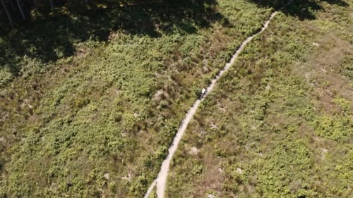 Drone Shot Of Cyclist Riding Through Field