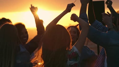 Friends Dancing at Rooftop Party During Sunset