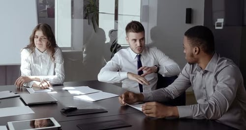 Two Male Partner Colleagues and Business Woman Leader Sitting at Office Table on Break Between