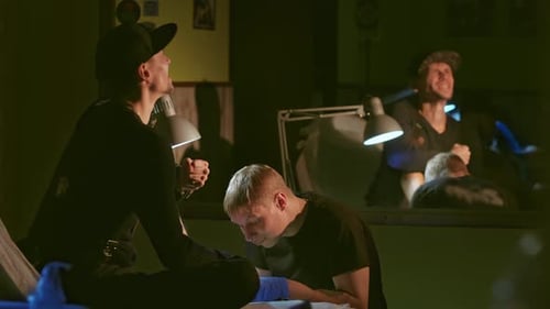 Tattoo Artist Working in Studio on Client