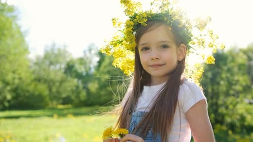 Smiling Girl with Flower Crown in Sunny Meadow