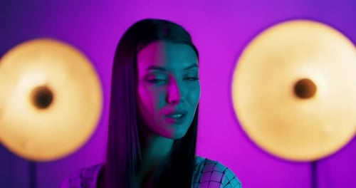 High Fashion Model Woman in Colorful Bright Lights Posing in Studio Portrait of Beautiful Sexy Girl