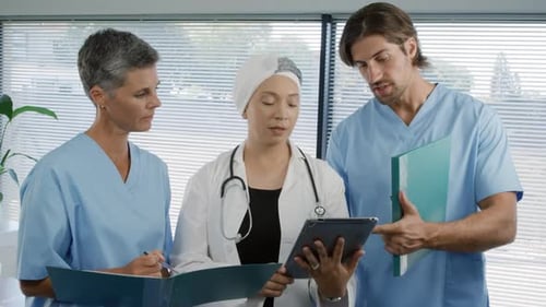 Medical Team Discussing Diagnosis in Hospital Office