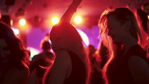 Women Dancing at Nightclub with Red Lighting