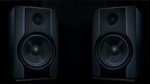 Close Up of Two Speakers on Dark Background