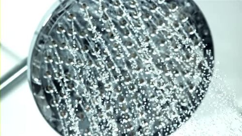 Modern Shower Head Streaming Water in Bathroom