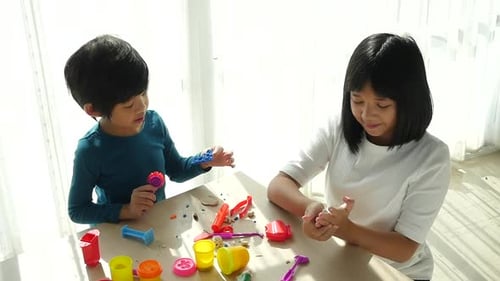 Kids Play with Play Dough at Table