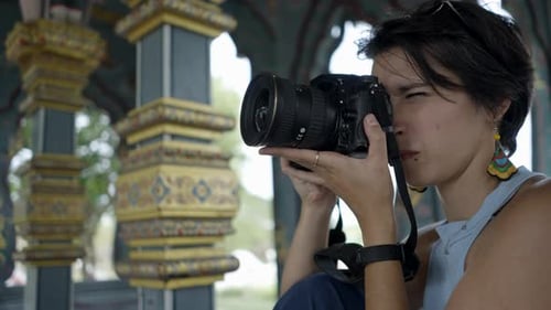Woman Taking Pictures With A Digital Camera In Ancient City Museum Park In Thai Ban Mai Thailand