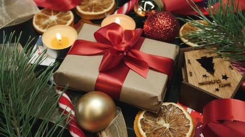 Wrapped crafted christmas gift with red ribbon. Happy New Year 2021