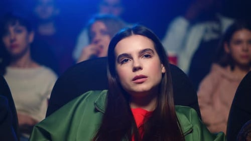 Closeup Scared Woman Watching Horror Movie in Cinema. Girl Feeling Wonder