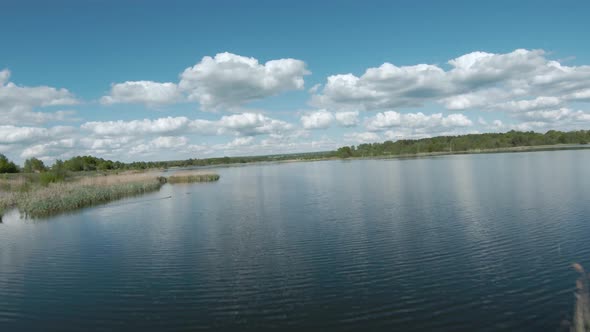 Fast and Agile Flight Over the Lake with a Pair of White Swans ...