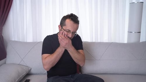 Man suffering from toothache.