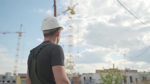 Construction Worker Inspecting Urban Building Site