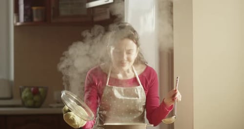 Woman Cooking Delicious Meal in Home Kitchen