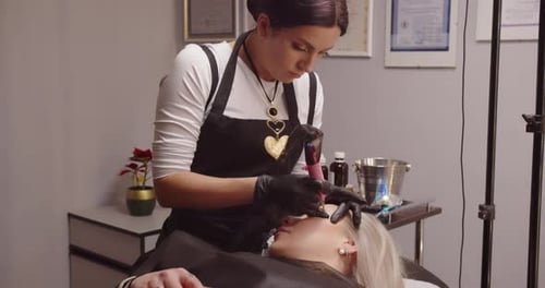 Beauty Technician Applying Permanent Makeup to a Client