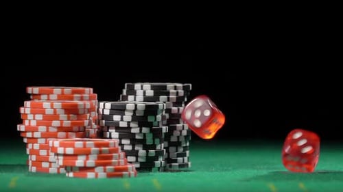 Poker Chips and Dice Falling on Table