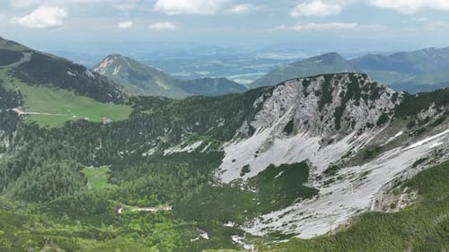 Majestic Mountain Range Under Partly Cloudy Sky