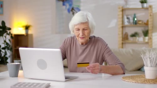 Senior Woman Shopping Online With Credit Card