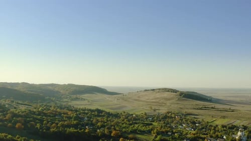 Scenic Aerial of Rolling Hills and Green Countryside