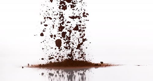 Chocolate Powder falling against White Background, slow motion 4K