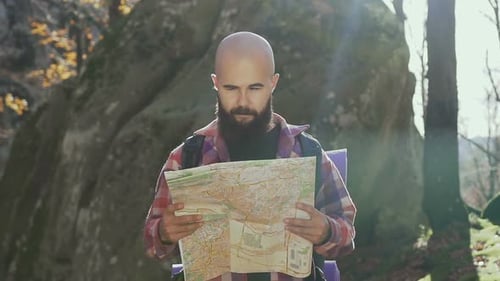 Young Bearded Man Wearing a Shirt in a Cage is Joyfully Walking Along the Torest Path