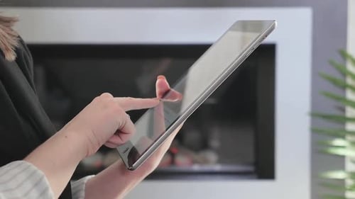 Woman Using Tablet Device at Home