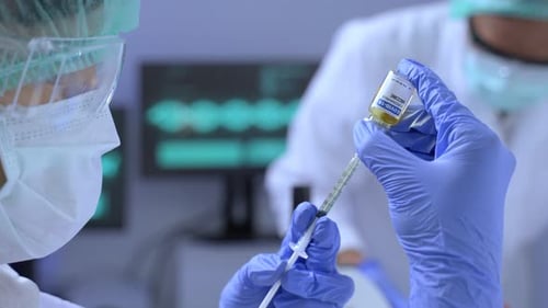 Scientist Filling Syringe with COVID-19 Vaccine in Lab