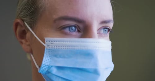 Woman Wearing Light Blue Surgical Mask Close Up