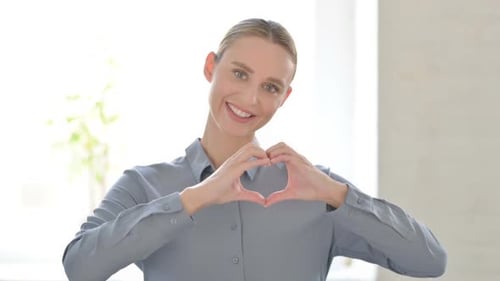 Woman Makes Heart Shape with Hands, Smiling