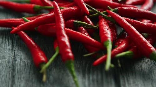 Pile of Red Chili Peppers on Wooden Background
