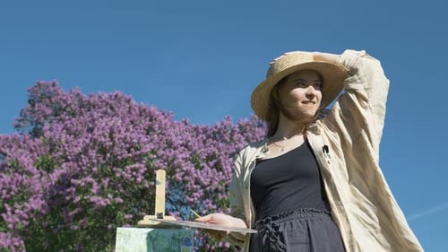 Woman Painting Outdoors on a Sunny Spring Day