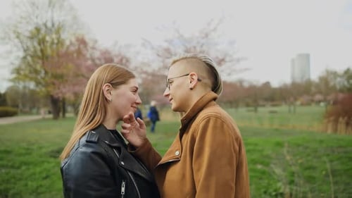 Tender LGBT Couple Standing Together and Smiling in Park