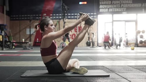 Sportswoman stretching in gym
