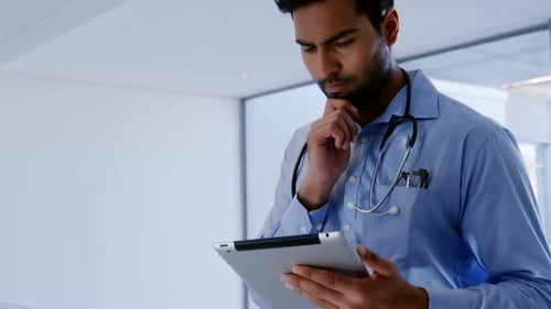 Male doctor using digital tablet