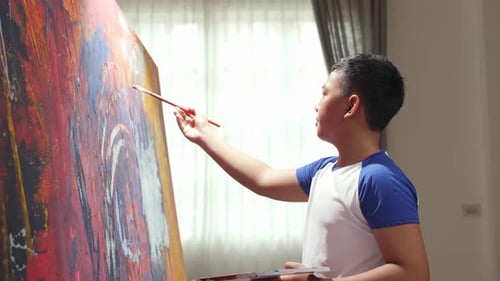 Young Boy Painting Abstract Art on Canvas