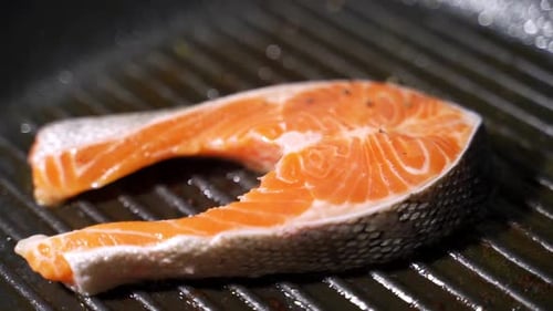 Close Up Cooking Salmon on Pan with Spices