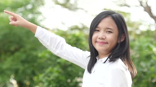 Close Up Of Asian Girl Pointing On Nature Background