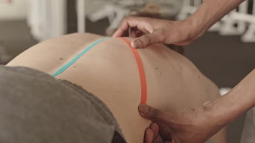 Applying Kinesiology Tape to an Adult's Back